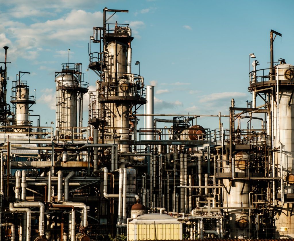 An industrial refinery facility featuring a series of large metal pipes