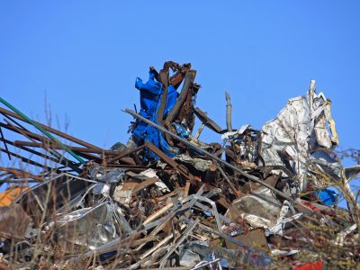 pile-of-scrap-metal-against-bright-blue-sky-2026-01-09-13-54-00-utc